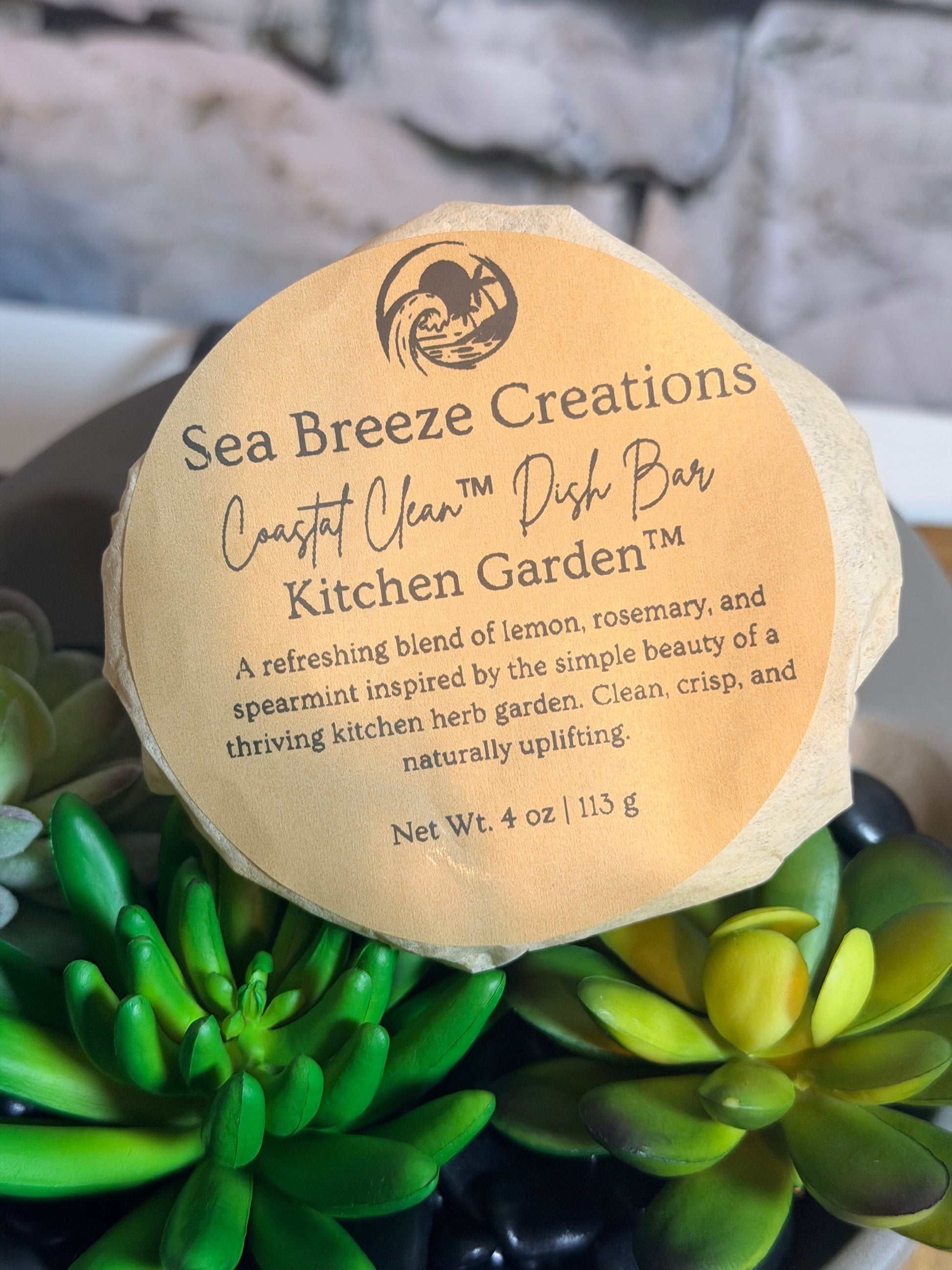 Sea Breeze Creations soap bar with a label on a background of green plants