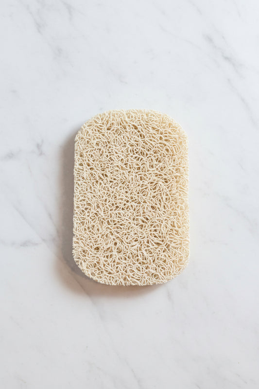 Natural loofah sponge on a marble surface