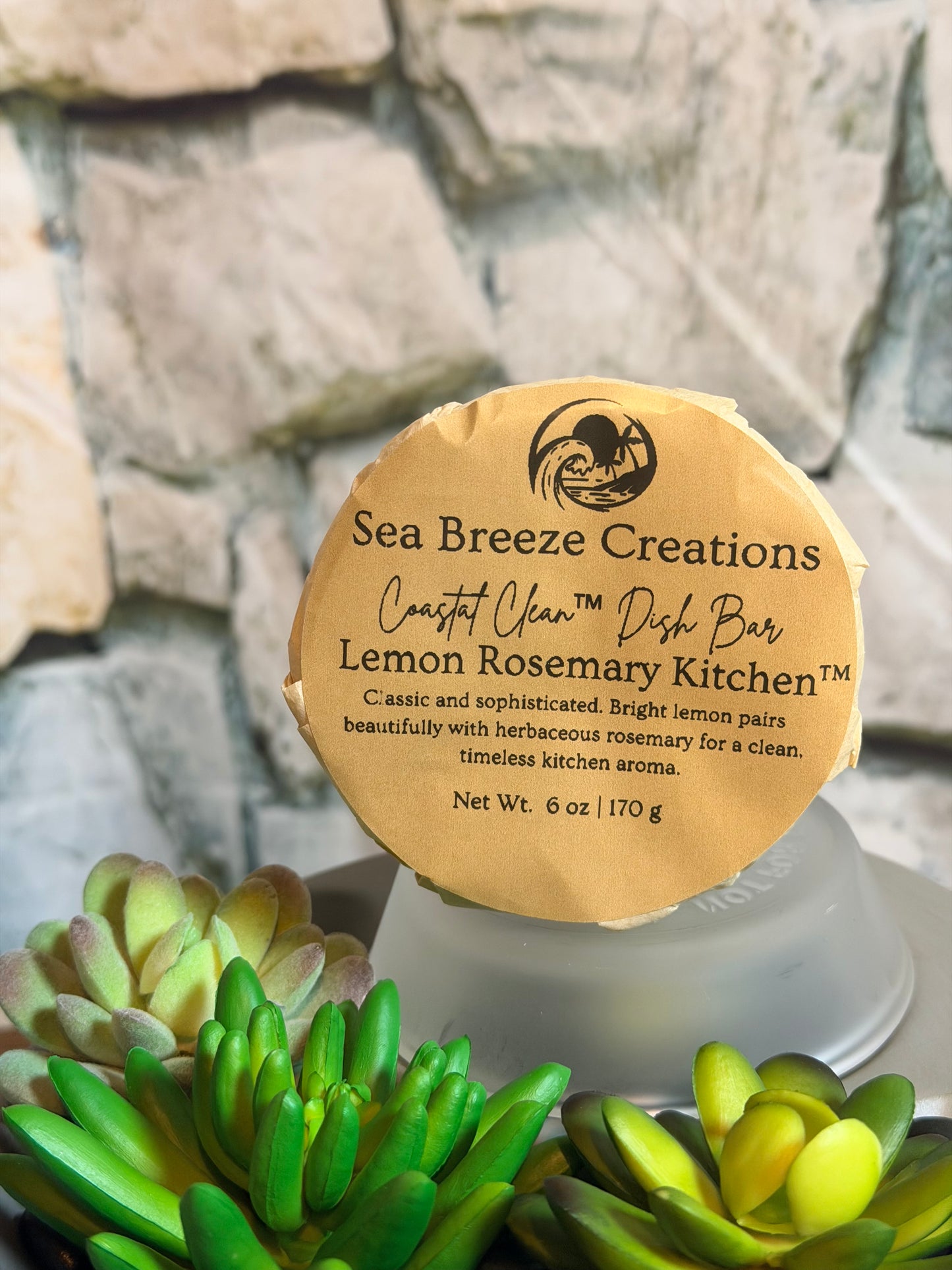 Sea Breeze Creations lemon rosemary kitchen candle with succulent plants in the background