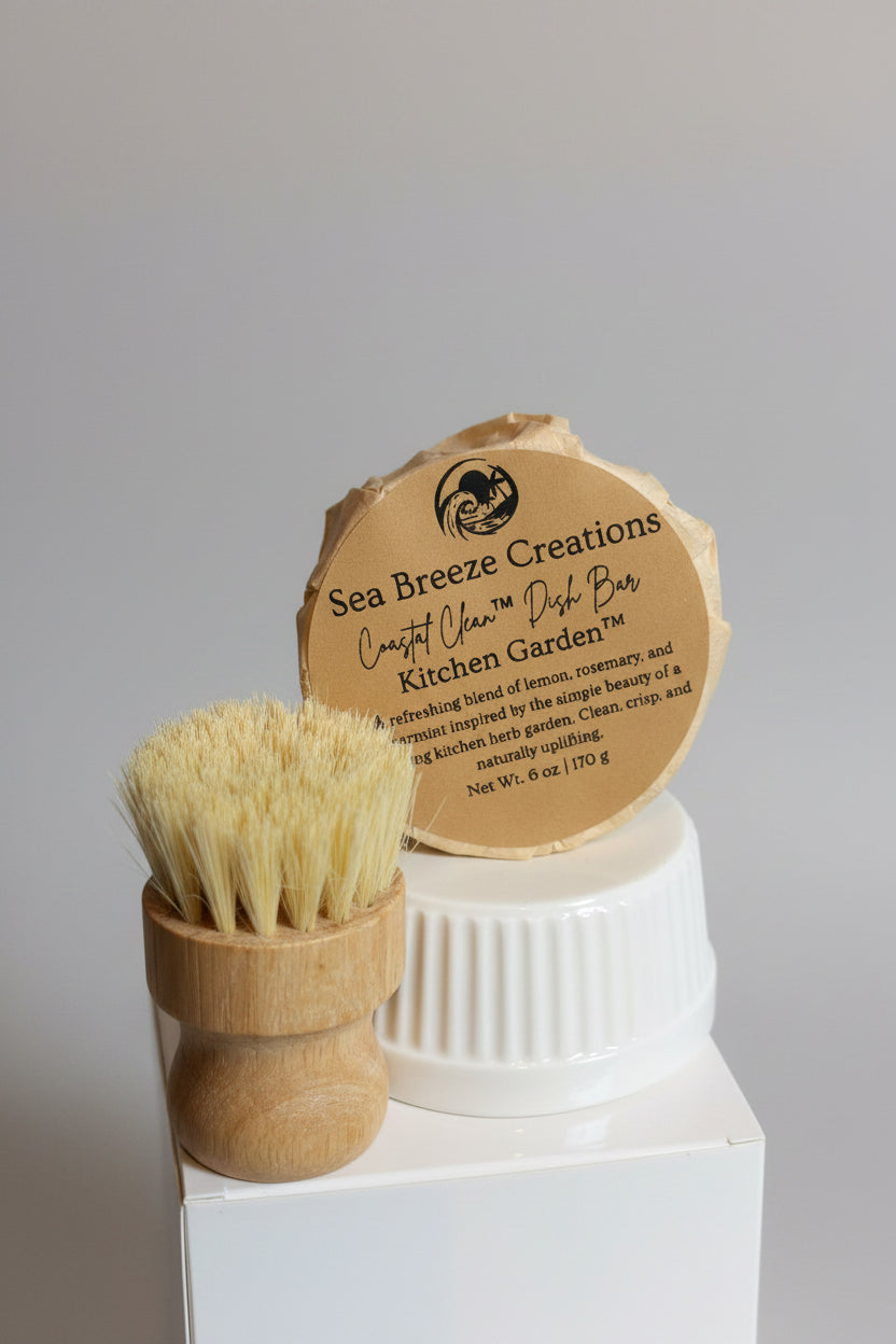 Bamboo dish brush and dish bar with 'Sea Breeze Creations' label on a gray background