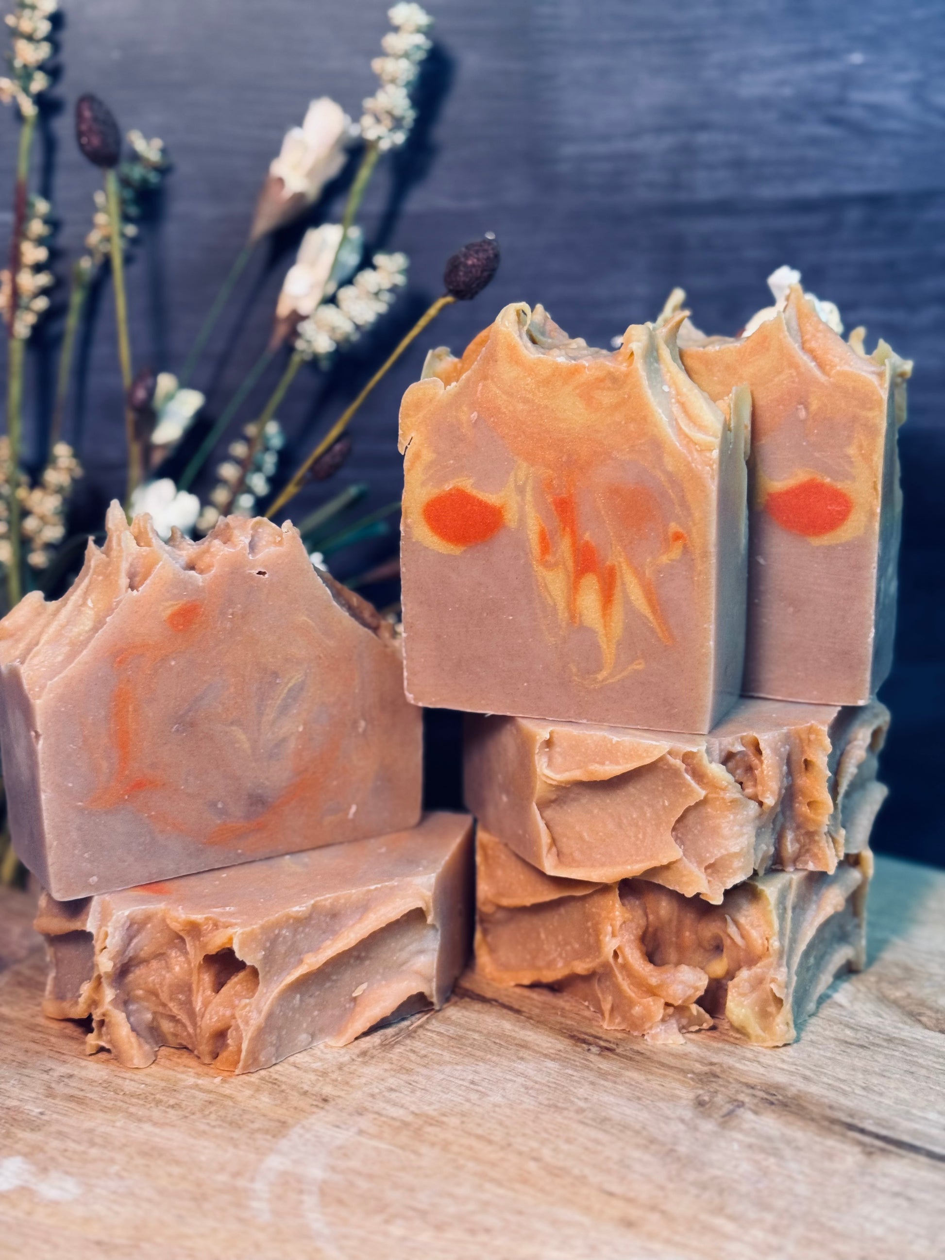 Bar soaps with marbled design on a wooden surface